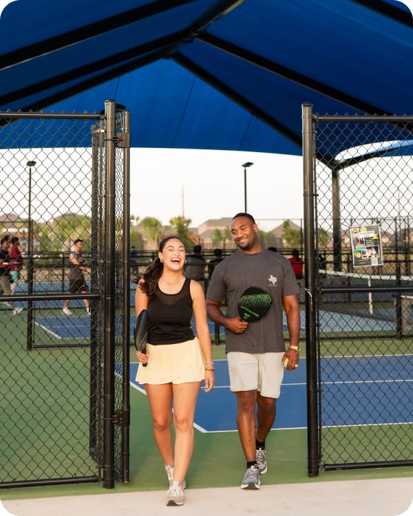 Couple walking off the pickleball courts at Revelry